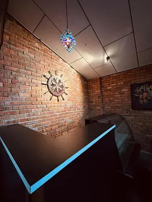 a brick wall with a clock on the wall at Maxwell inn in Taiping
