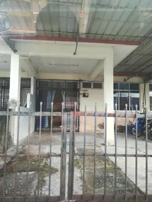 a fence in front of a parking lot at Homestay siti in Padang Serai