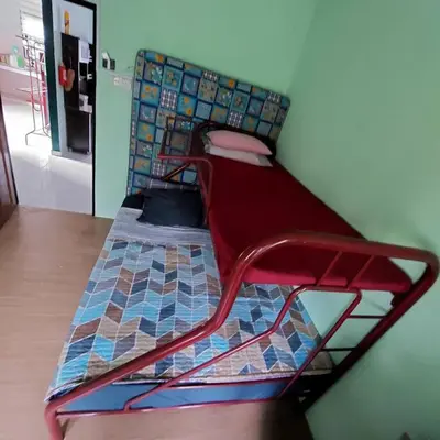 a bed with a red frame in a room at Adam Homestay in Ipoh