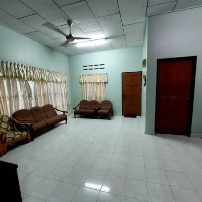 a living room with couches and chairs in a room at Adam Homestay in Ipoh