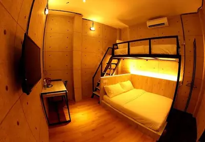 a room with two bunk beds and a television at Merge Summit by Secoms in Teluk Intan