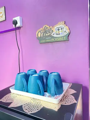 a table with blue vases on top of it at AISY HOMESTAY - Rumah 2 atau 3 in Kampong Tanjong Karang