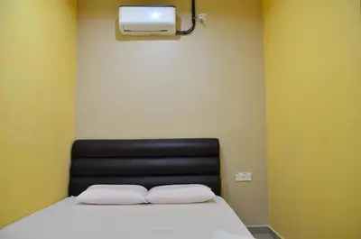 a bed with two white pillows in a room at Deena Hotel Bajet in Gua Musang