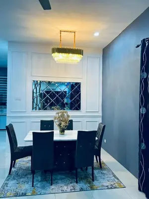 a dining room with a table and chairs and a chandelier at SRS WIN Homestay in Sungai Petani