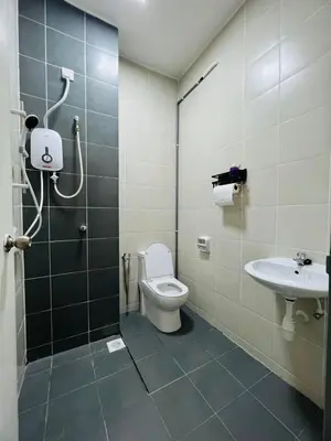 a bathroom with a shower and a toilet and a sink at SRS WIN Homestay in Sungai Petani