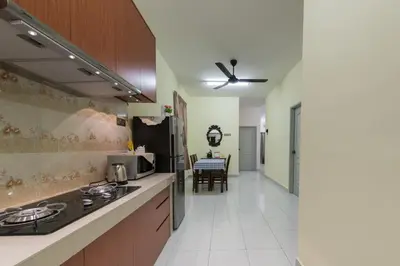 a kitchen with a sink and a stove at Zai Ham Homestay in Pusing