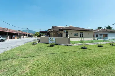 a house on a street with a yard at Zai Ham Homestay in Pusing