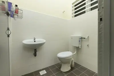 a bathroom with a toilet and a sink at Zai Ham Homestay in Pusing
