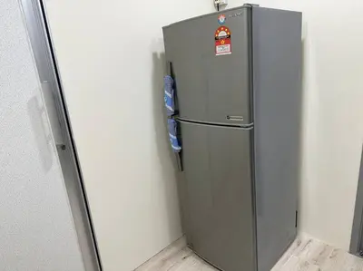 a silver refrigerator in a corner of a room at CEO7 Duplex Business Suite#Disneys HS#USM#Pisa#Pantai Hospital in Bayan Lepas