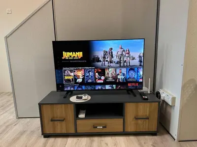 a flat screen tv on a stand in a room at CEO7 Duplex Business Suite#Disneys HS#USM#Pisa#Pantai Hospital in Bayan Lepas