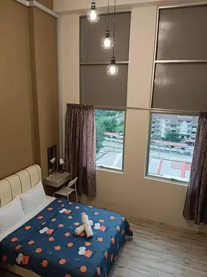 a bedroom with a bed with a teddy bear on it at CEO7 Duplex Business Suite#Disneys HS#USM#Pisa#Pantai Hospital in Bayan Lepas