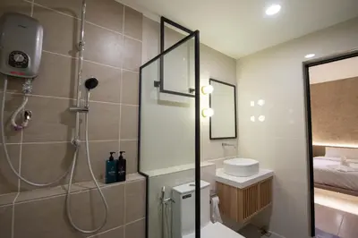 a bathroom with a shower and a toilet at DeLuma-Lebuh Acheh in George Town