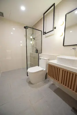 a bathroom with a toilet and a shower and a sink at DeLuma-Lebuh Acheh in George Town