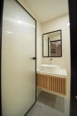 a bathroom with a sink and a mirror at DeLuma-Lebuh Acheh in George Town