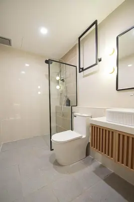 a bathroom with a toilet and a glass shower at DeLuma-Lebuh Acheh in George Town