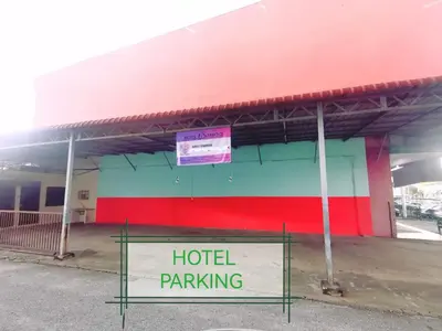 a building with a hotel parking sign in front of it at Shangg INN in Ipoh