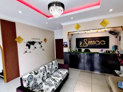 a store with a couch and a sign on the wall at Shangg INN in Ipoh