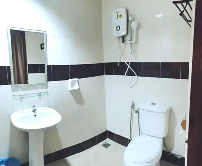 a bathroom with a toilet and a sink at Shangg INN in Ipoh