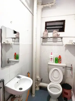 a bathroom with a white toilet and a sink at EC12-Georgetown-3room-PrivateHouse in Jelutong