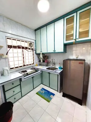 a kitchen with blue cabinets and a stainless steel refrigerator at EC12-Georgetown-3room-PrivateHouse in Jelutong