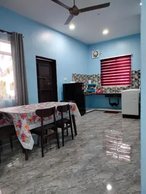 a dining room with a table and some chairs at Rizki Homestay Nibong Tebal in Nibung Tebal