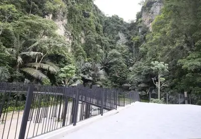 a black fence in front of a mountain with trees at IPOH The COVE at Ipoh Garden East 7 PAX Cozy Fully Air-Con in Ipoh