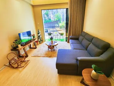 a living room with a blue couch and a table at IPOH The COVE at Ipoh Garden East 7 PAX Cozy Fully Air-Con in Ipoh