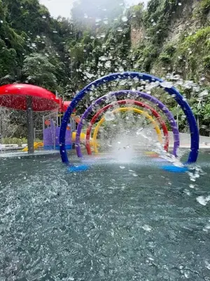 a water park with a rainbow in the water at IPOH The COVE at Ipoh Garden East 7 PAX Cozy Fully Air-Con in Ipoh