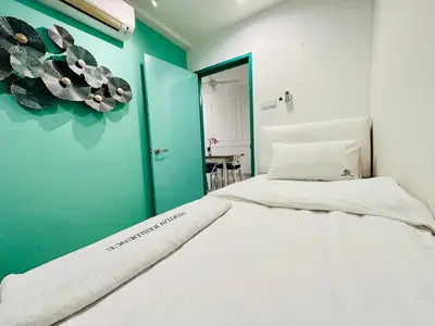 a bedroom with a bed and a blue wall at The Majestic-Loft De Tel in Ipoh