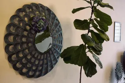 a mirror hanging on a wall with a plant at The Majestic-Loft De Tel in Ipoh