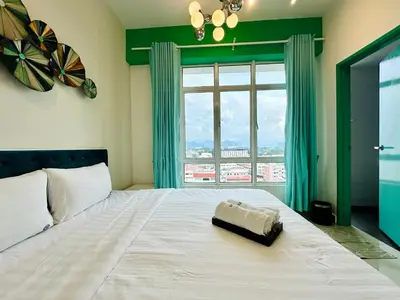 a bedroom with a large bed with a large window at The Majestic-Loft De Tel in Ipoh