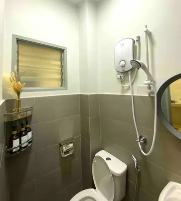 a bathroom with a white toilet and a mirror at Stylish Cozy House Near Ipoh Lost World Tambun in Kampong Batu Lapan