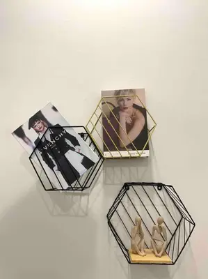 three photos and a figurine in a box on a table at Stylish Cozy House Near Ipoh Lost World Tambun in Kampong Batu Lapan