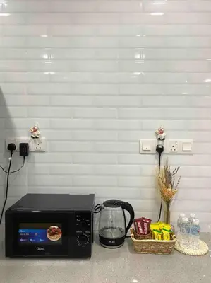 a microwave sitting on a counter with a basket of food at Stylish Cozy House Near Ipoh Lost World Tambun in Kampong Batu Lapan
