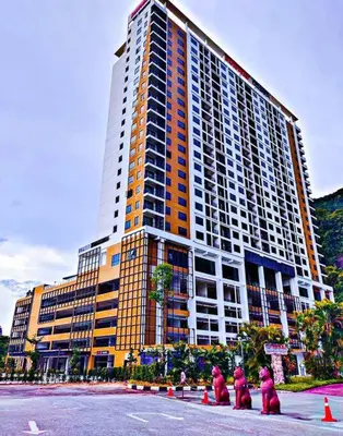 a group of people dressed in pink in front of a large building at Studio suite nearby Lost World of Tambun in Tambun