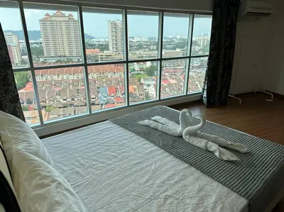 a bed with two white towels on it with a large window at CEO9 Duplex Premier 6 Pax Suite#Disneys HS #PISA #USM #Pantai Hospital in Bayan Lepas