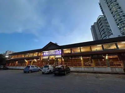 a building with cars parked in a parking lot at CEO9 Duplex Premier 6 Pax Suite#Disneys HS #PISA #USM #Pantai Hospital in Bayan Lepas