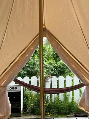 an inside view of a tent in front of a white fence at The Backyard Glamping Cameron Highlands in Tanah Rata