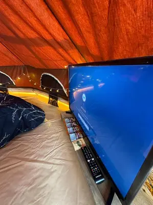 a laptop computer sitting on top of a bed at The Backyard Glamping Cameron Highlands in Tanah Rata