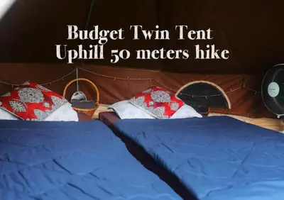 two beds in a room with the words buject twin tentjit meters hike at The Backyard Glamping Cameron Highlands in Tanah Rata