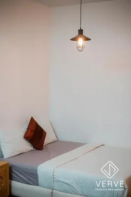 a bedroom with a bed with a light on it at Ipoh 188 Private Pool Mansion by Verve 30 pax EECH119 in Ipoh