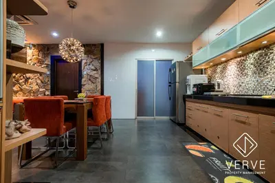 a kitchen and dining room with a table and a refrigerator at Ipoh 188 Private Pool Mansion by Verve 30 pax EECH119 in Ipoh