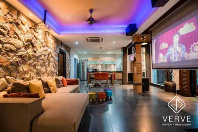 a living room with a couch and a large screen at Ipoh 188 Private Pool Mansion by Verve 30 pax EECH119 in Ipoh