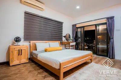 a bedroom with a bed and a desk and a window at Ipoh 188 Private Pool Mansion by Verve 30 pax EECH119 in Ipoh