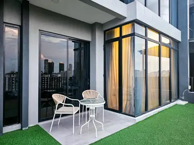 a patio with a table and chairs on a balcony at Beacon Executive Suite by NGN - Georgetown Penang in George Town