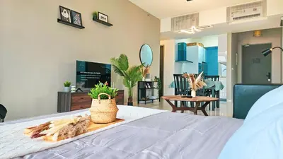 a bedroom with a bed with a tray of food on it at Beacon Executive Suite by NGN - Georgetown Penang in George Town
