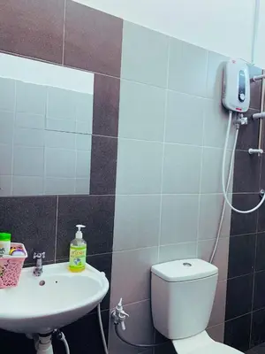 a bathroom with a toilet and a sink at D' Splash Garden Homestay in Baling