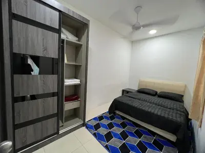a bedroom with a bed and a closet at idaman hill homestay in Ipoh