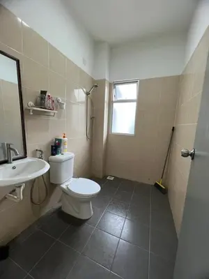 a bathroom with a white toilet and a sink at idaman hill homestay in Ipoh