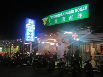 a group of motorcycles parked outside of a restaurant at night at 311 Pangkor Coral Bay Homestay in Pasir Bogak